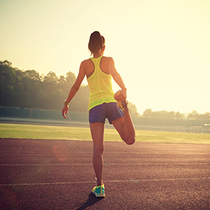 Woman stretching before a run after having her knee cared for by an orthopedic specialist.